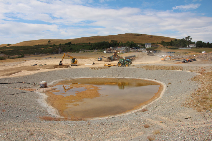 Laying soil on geosynthetic clay liner